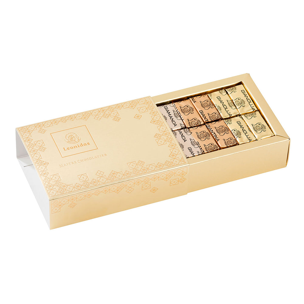 A beautiful gold bar gift box filled with our Gianduja collection: the Gianduja with finely ground nuts, the Giantina with pieces of feuilletine (biscuit), and the Giamanda with pieces of almond.